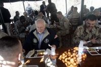 U.S. Vice President Dick Cheney eats with U.S. and Iraqi soldiers at the Taji Air Base in Iraq Sunday, Dec. 18, 2005. Cheney also met with Iraqi leaders and U.S. Military Command to discuss security and the latest elections during his surprise visit. (AP Photo/Lawrence Jackson, Pool)